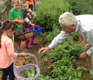 Gachina Landscape Management recently converted 5,000 square feet of their construction yard into an organic vegetable garden that was awarded a Certified Wildlife Habitat™ designation by the National Wildlife Federation. Here, company president, CEO and founder John Gachina works with children in the demonstration garden.