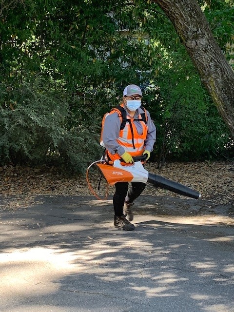 Employee holding a leaf blower