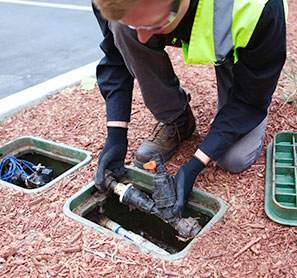 worker installing a pipe for irrigation